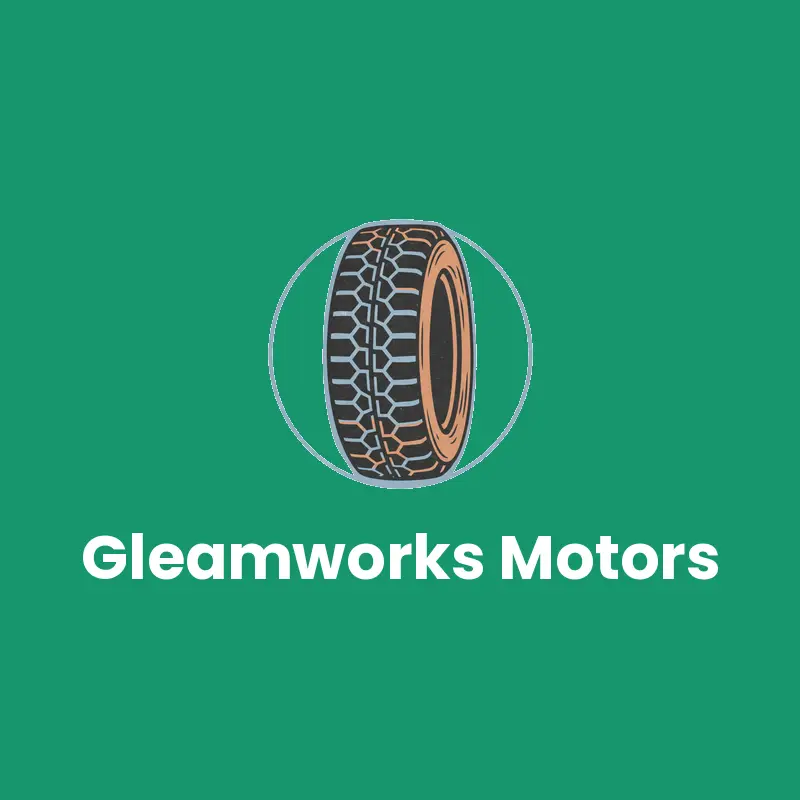 A cut ink tire with a deep tread pattern on green beside a tire and wheel shop name.